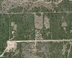Aerial photo of Burnett Ranch Section IV, Block 2 Lots 2-8 and Part of Section 5, Lots 57 and 58. Our property is the lot to the left of the cleared lot. Taken March 2004